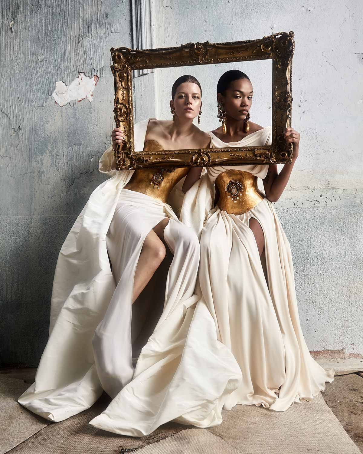 Two Girls in White Holding a Frame